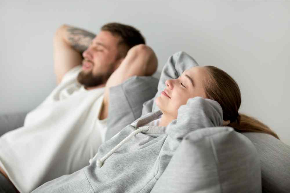 couple sitting back and relaxing on couch