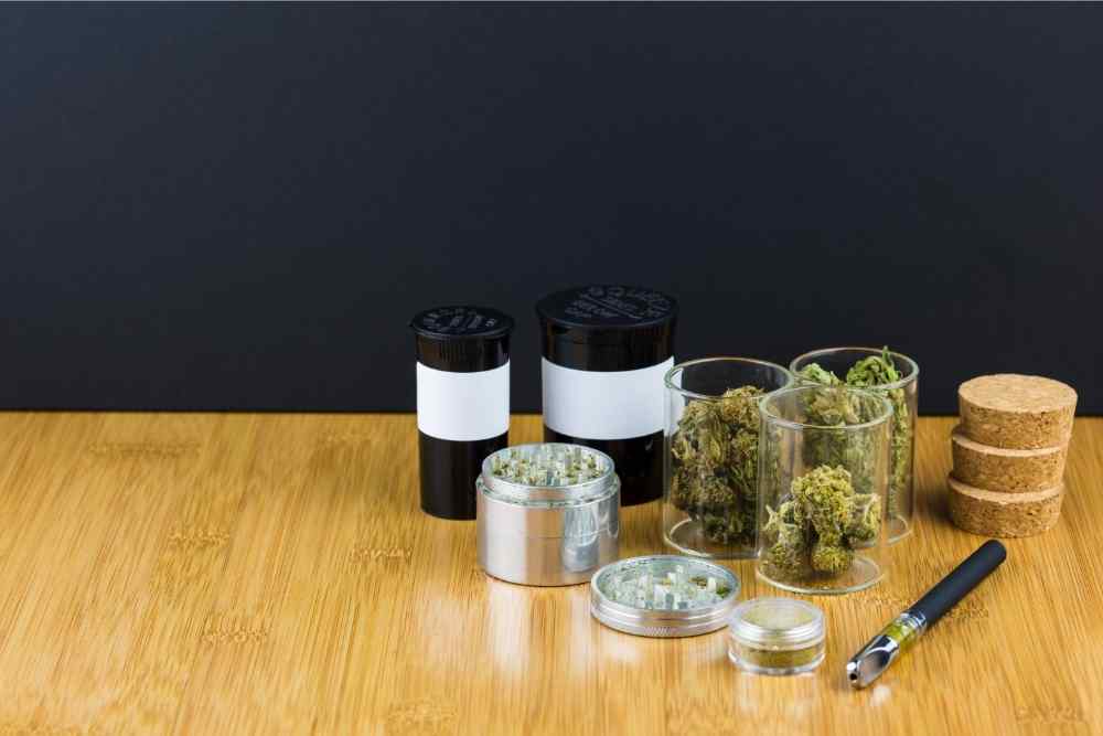 different cbd buds in jars with grinder
