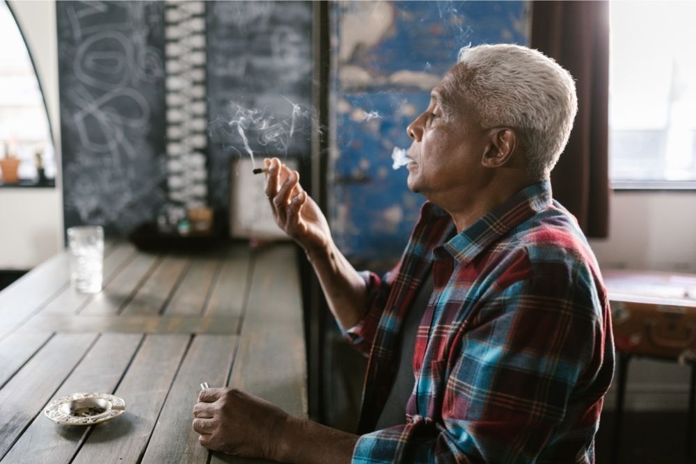 old man smoking flower