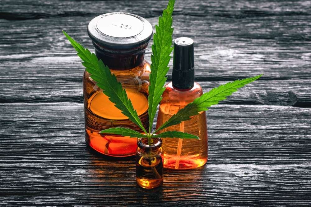 cbd-oil-with-leaf-and-two-bottles