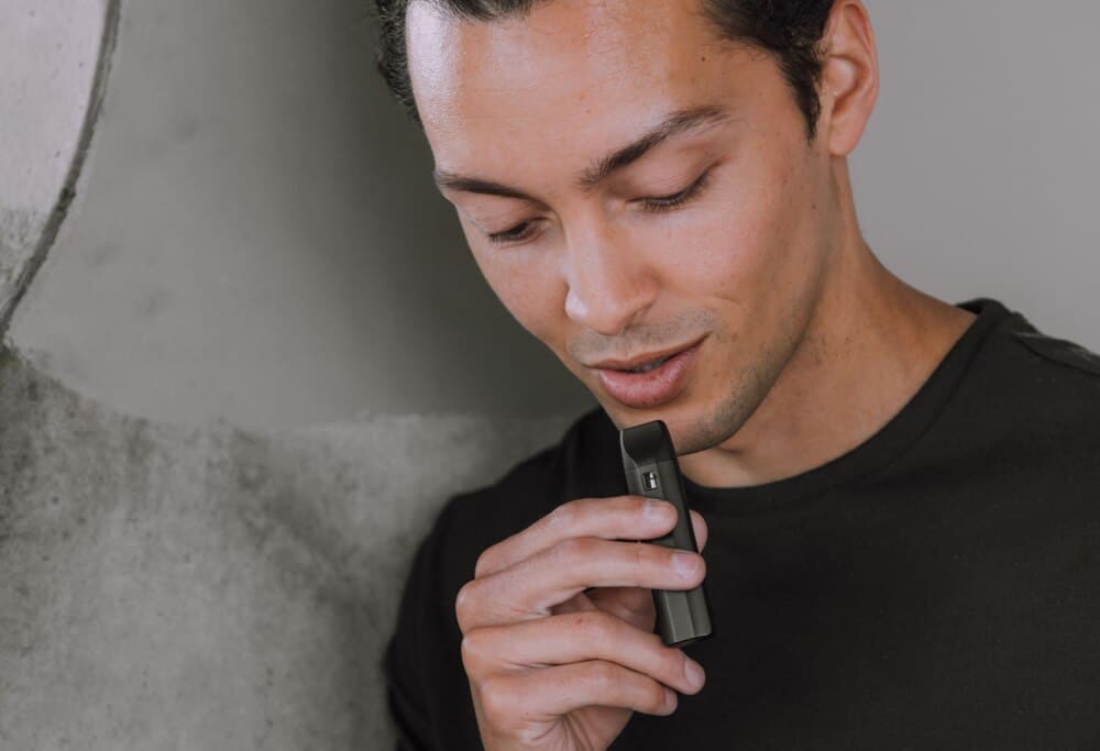 man using delta 8 thc disposable vape