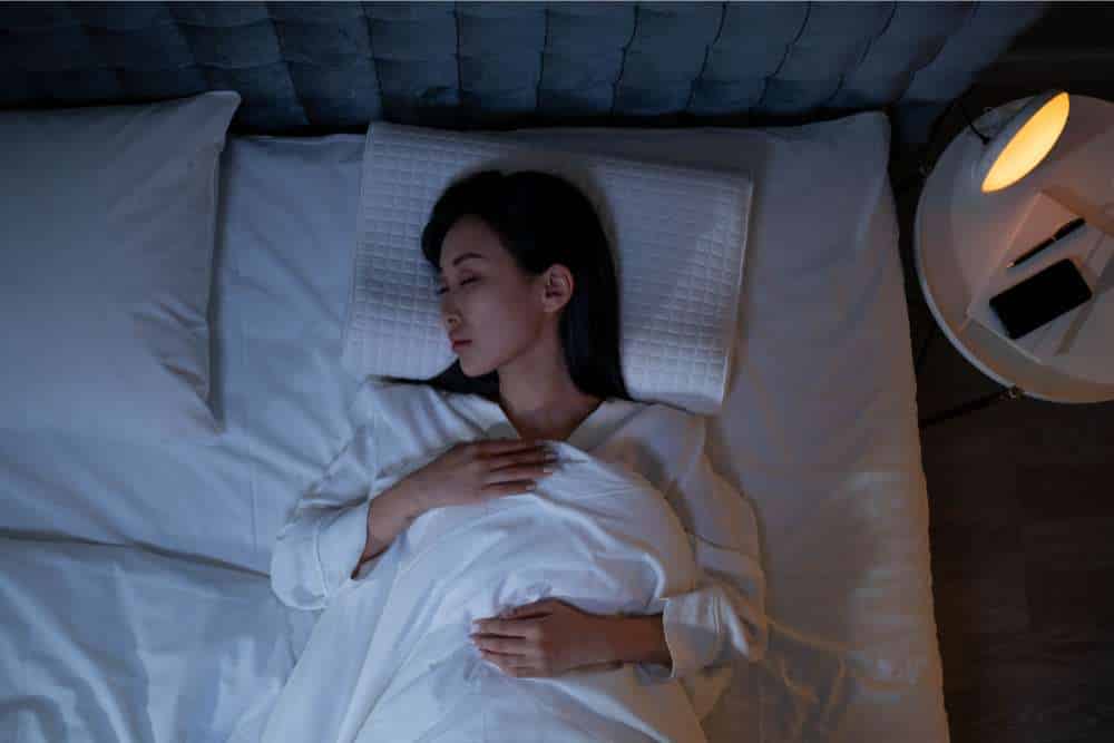 sleep gummies helping woman sleep in bed