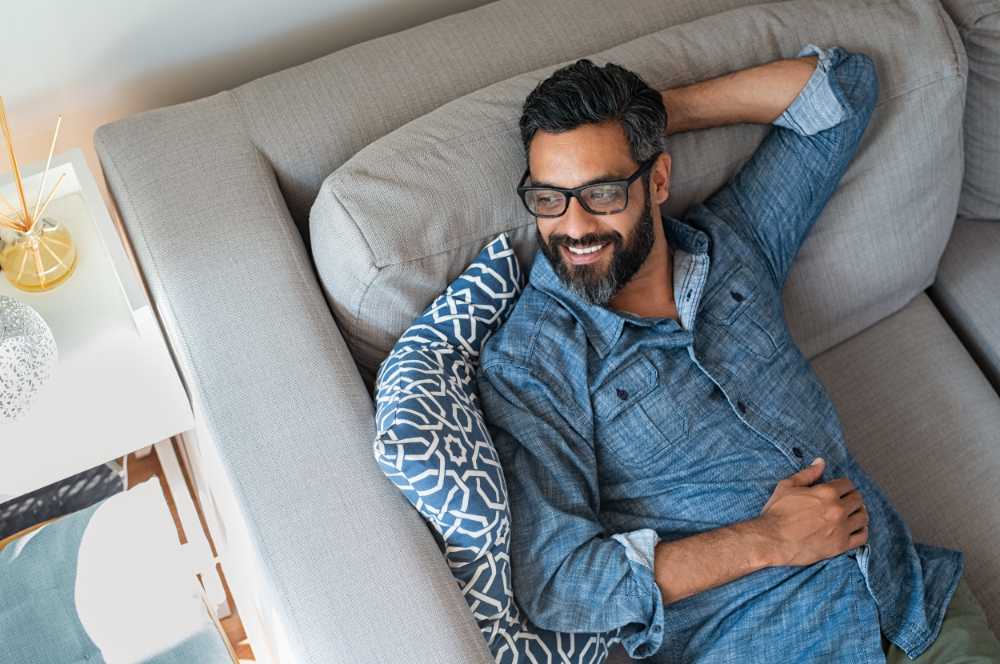 happy man relaxing on couch