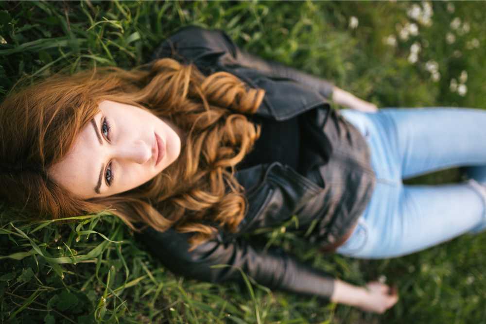 young woman relaxing in field