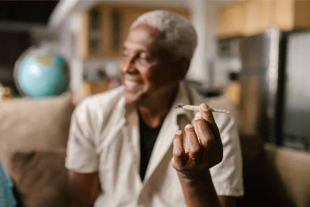happy man holding a joint