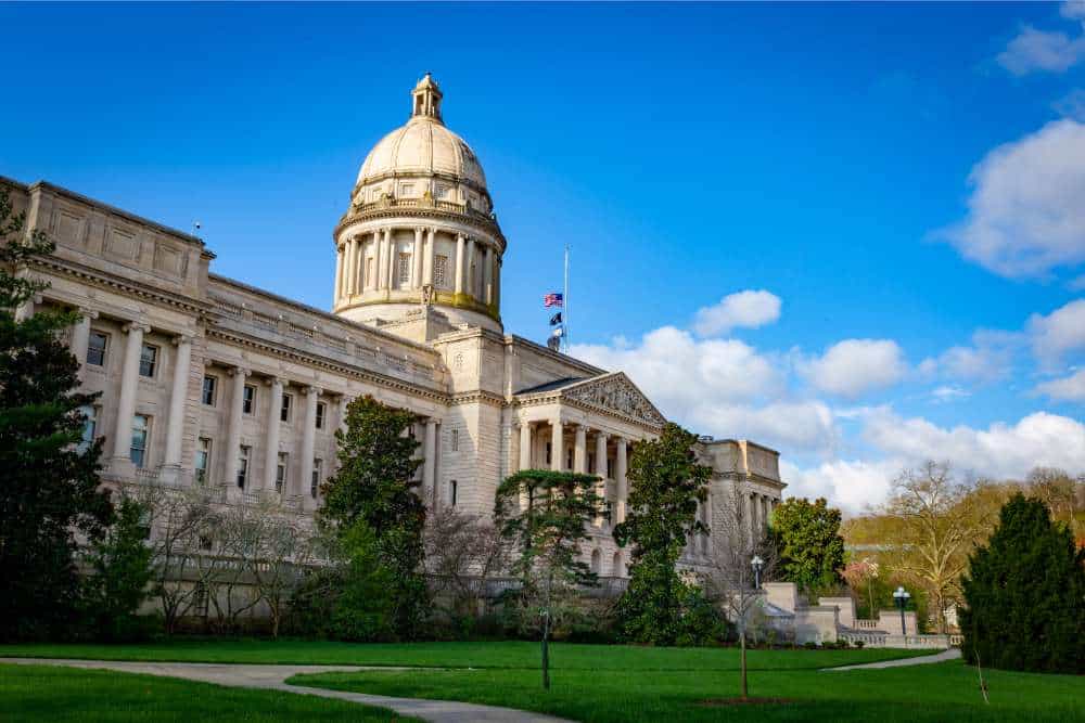 kentucky state capitol against bright blue sky with clouds dramatic