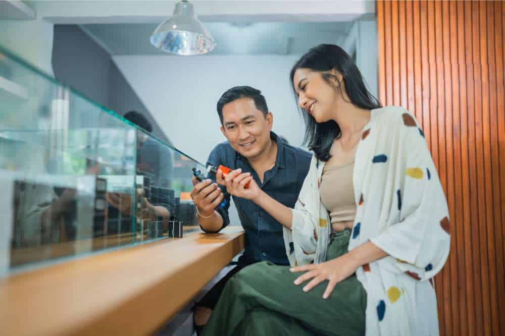 man and woman comparing vapes in store